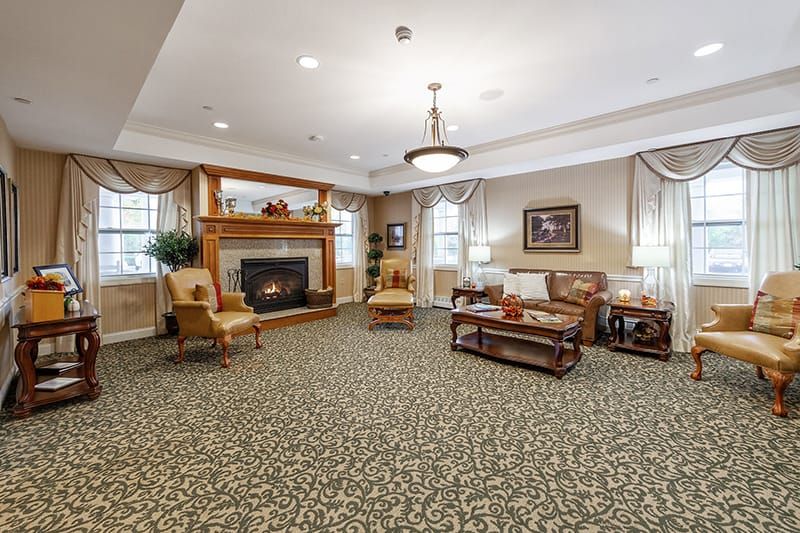 A cozy living room with a fireplace, elegant furniture, and stylish decor.