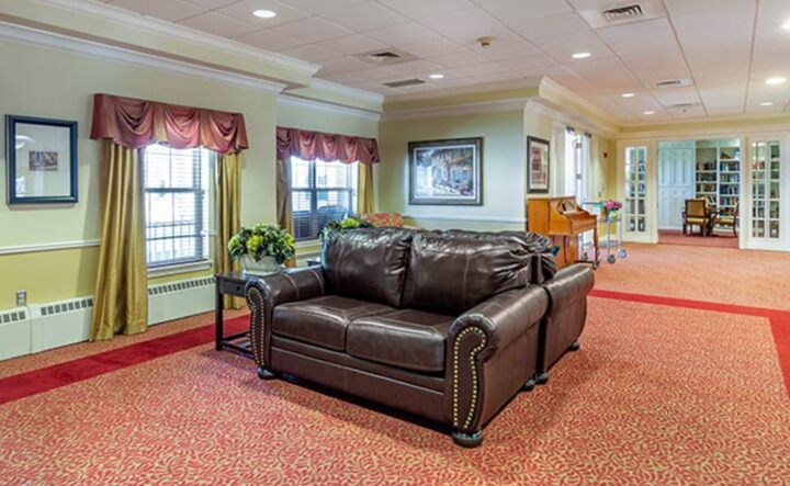 A cozy living room with a dark leather sofa and elegant decor.