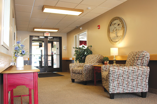 A cozy waiting area featuring comfortable chairs and a warm atmosphere.