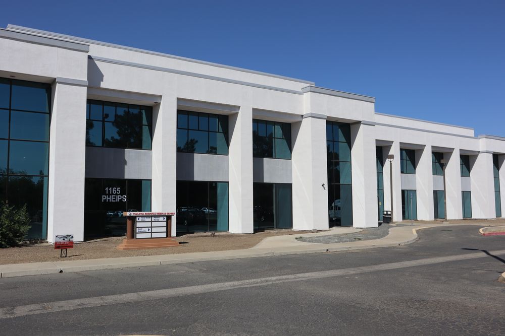 A modern commercial office building with large windows and a sleek design.