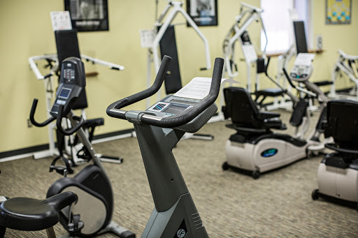 A view of a gym featuring various exercise machines, including a stationary bike.