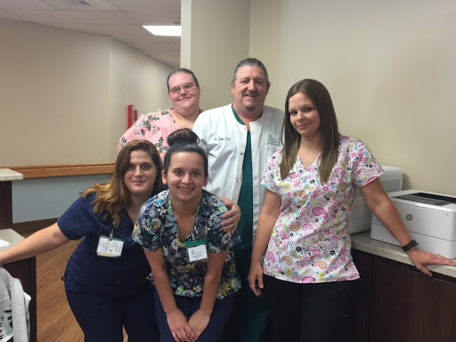 A dedicated healthcare team posing together in a hospital setting.