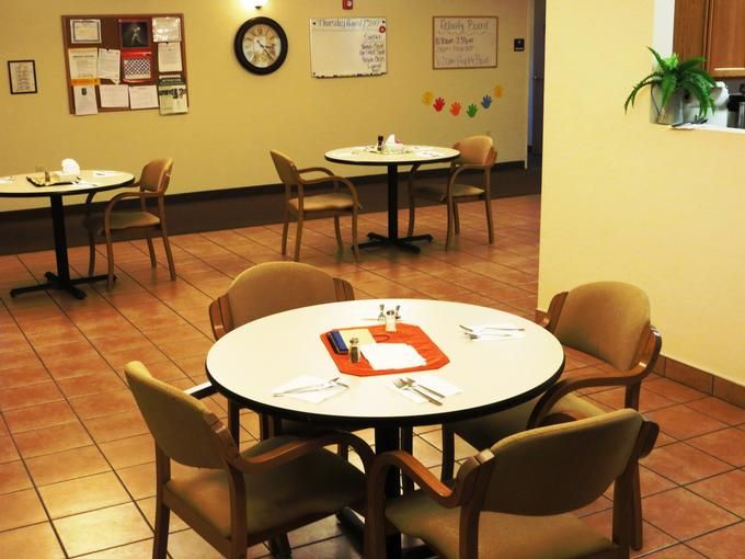 An indoor dining area with tables and chairs arranged neatly.
