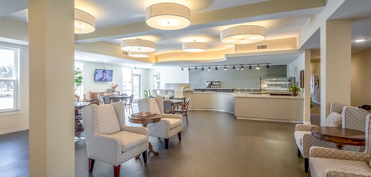 A modern cafe interior with comfortable seating and sleek lighting.