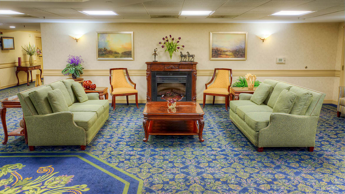 A cozy living room with sofas, chairs, a fireplace, and elegant decor.