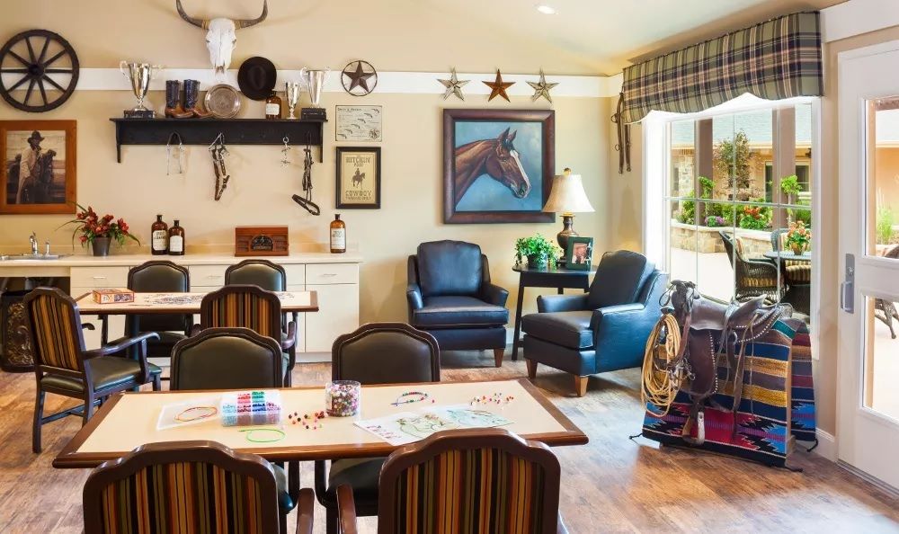 A cozy living room with equestrian-themed decor, featuring comfortable chairs and a dining table.