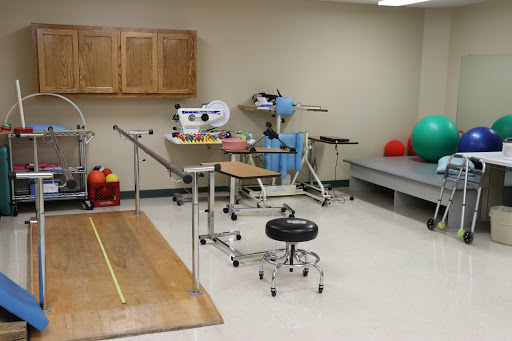 A well-equipped physical therapy room featuring various rehabilitation tools and equipment.