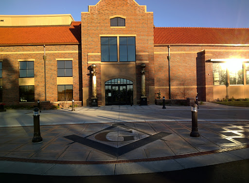A modern brick building featuring a welcoming entrance and well-maintained landscaping.