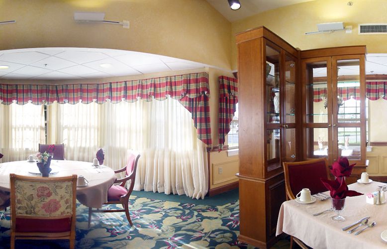 A cozy restaurant dining area with elegant furnishings and large windows.