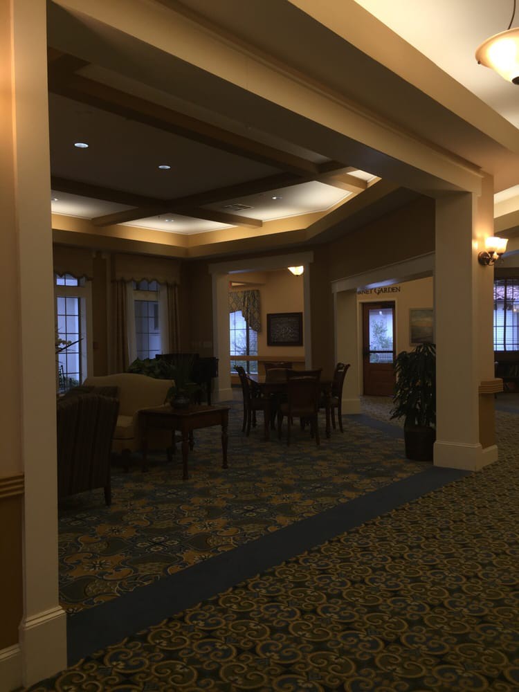 A cozy hotel lobby with seating arrangements and warm lighting.