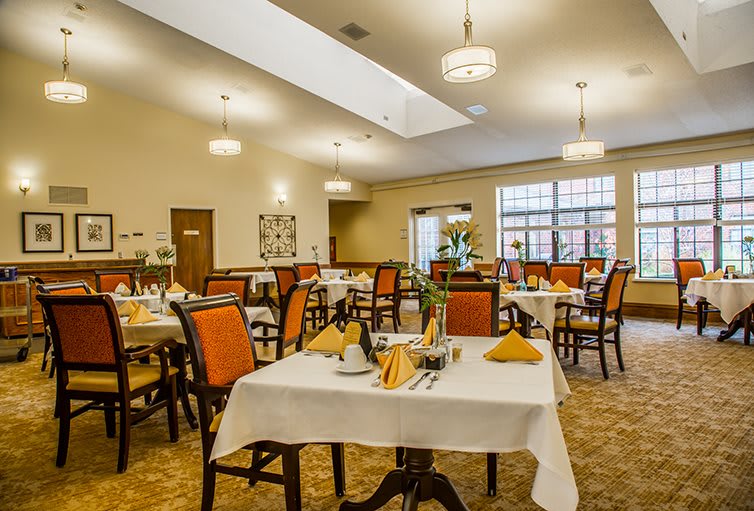 An elegant and well-decorated dining room with neatly arranged tables and chairs.