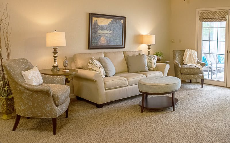 A cozy and well-decorated living room with comfortable seating and warm lighting.