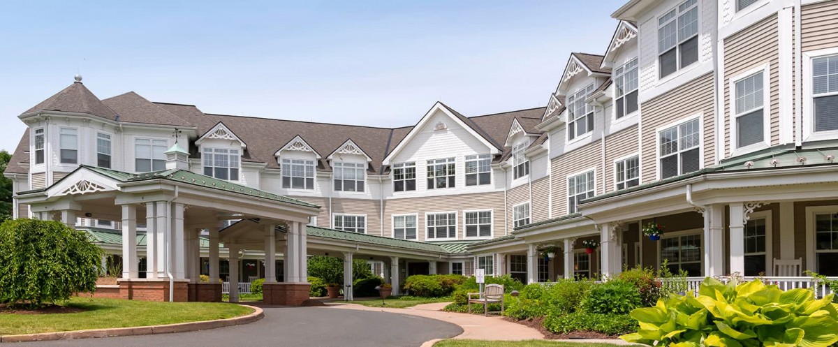 A residential building with a landscaped entrance.