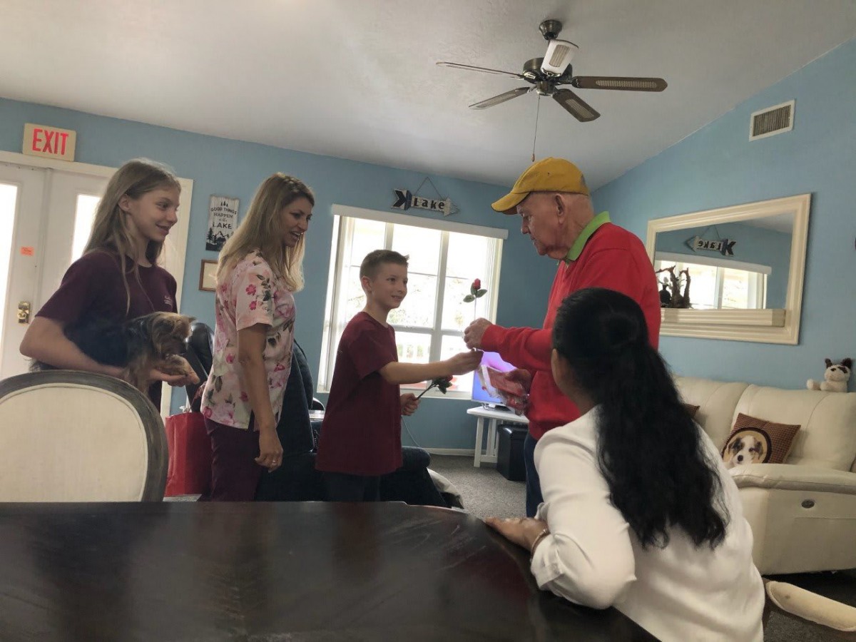 A group of people interacting in a casual indoor setting.