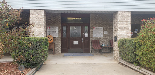 Entrance view of a building showcasing the main door and seating area.