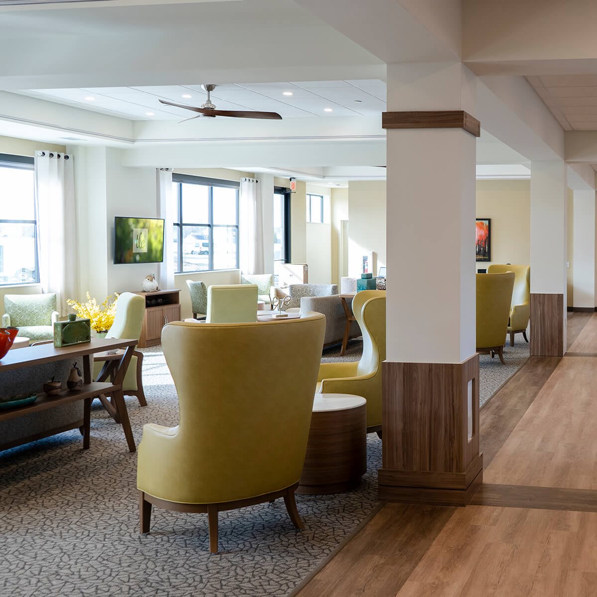 A modern living room with comfortable seating and large windows.