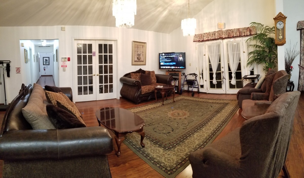 Cozy living room with elegant furnishings and a large rug.