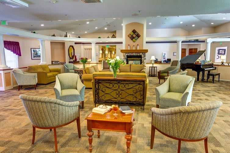 A spacious and elegantly designed lounge area featuring comfortable seating and a cozy ambiance.