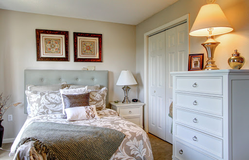A cozy and stylish bedroom featuring elegant furniture and decorative artwork.