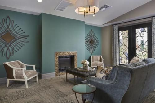 A stylish living room featuring a fireplace, modern furniture, and elegant decor.