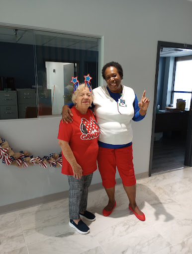 Two friends celebrating together with festive outfits and smiles.