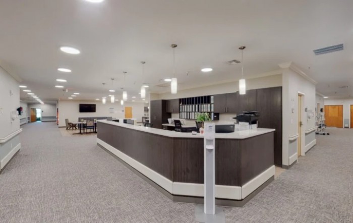 A modern reception area with a large counter and overhead lighting.