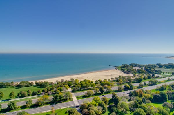 A scenic view of a beach with clear blue skies and tranquil waters.