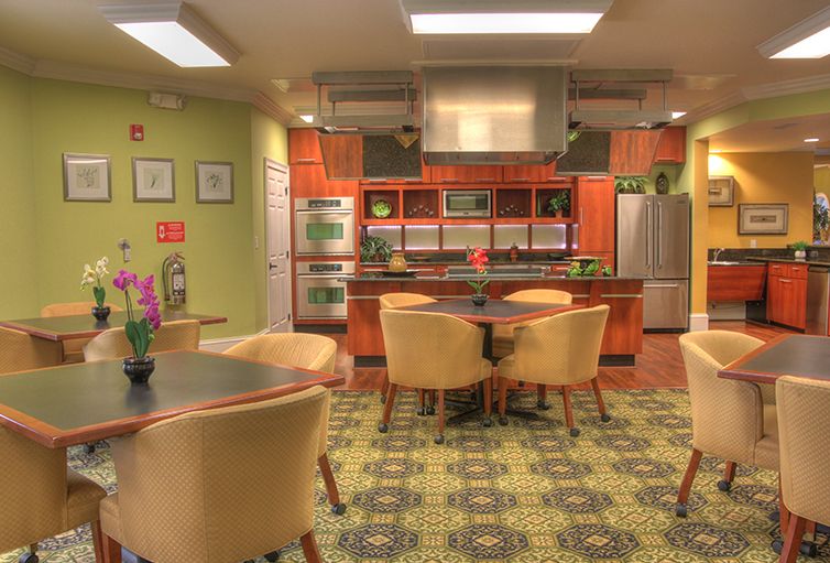A modern kitchen with a dining area featuring stylish seating and bright decor.
