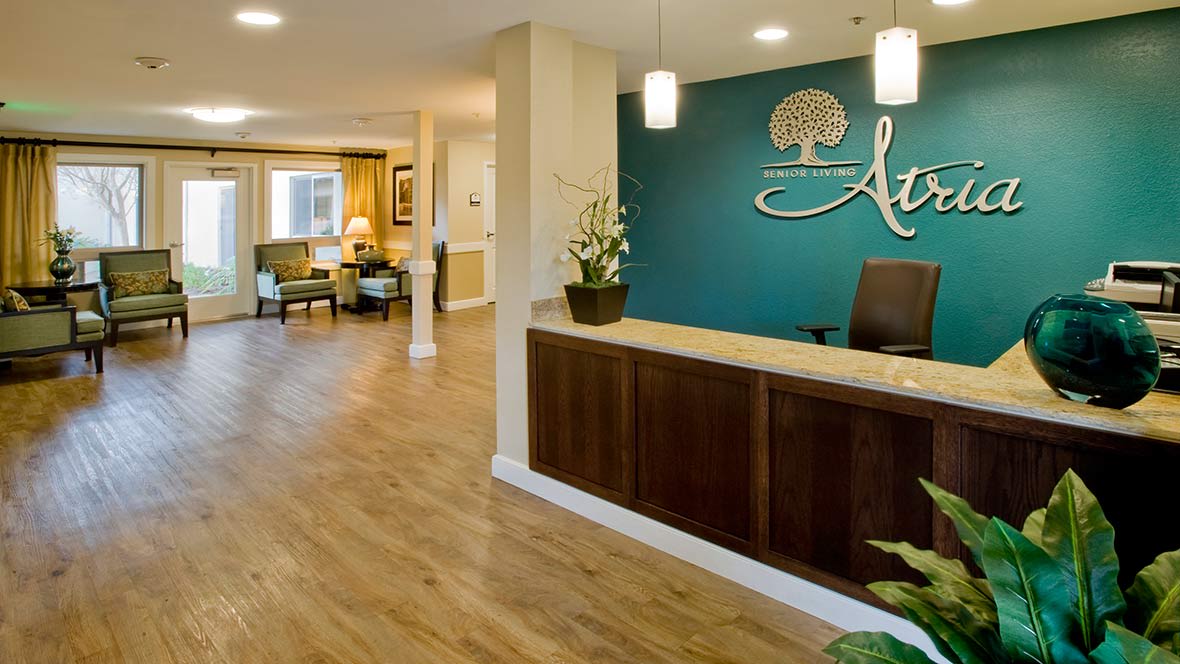 A modern reception area with a wooden desk and stylish decor.