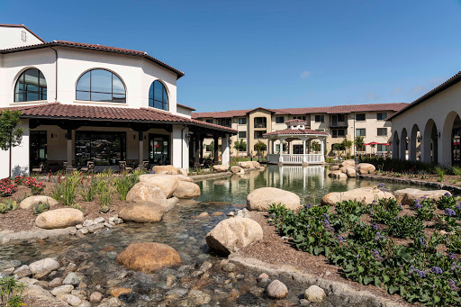A serene view of a modern resort featuring elegant architecture and tranquil landscaping.