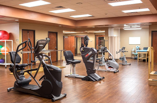 A well-equipped gym featuring various exercise machines for fitness enthusiasts.