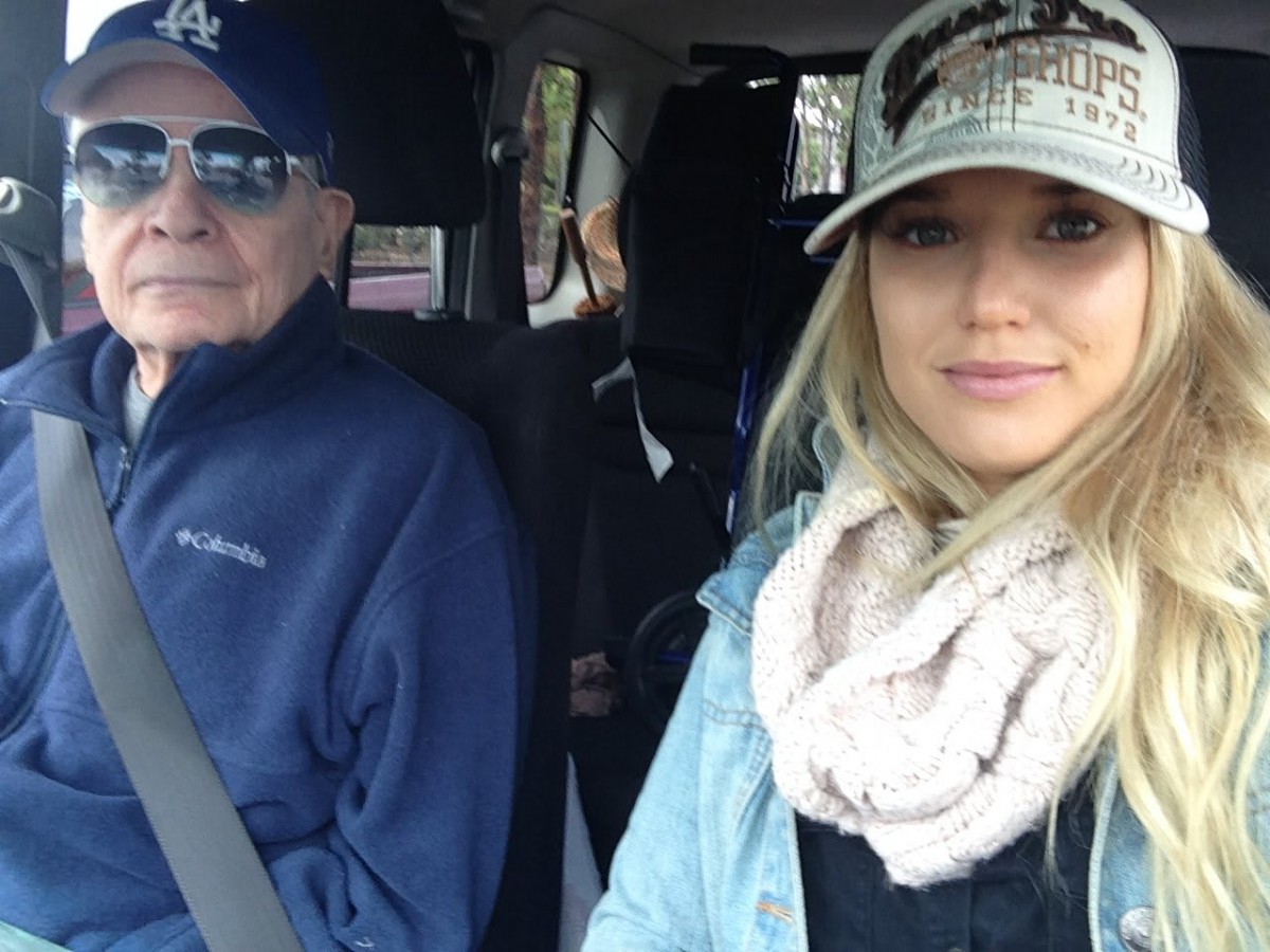 Two people taking a selfie in a car.