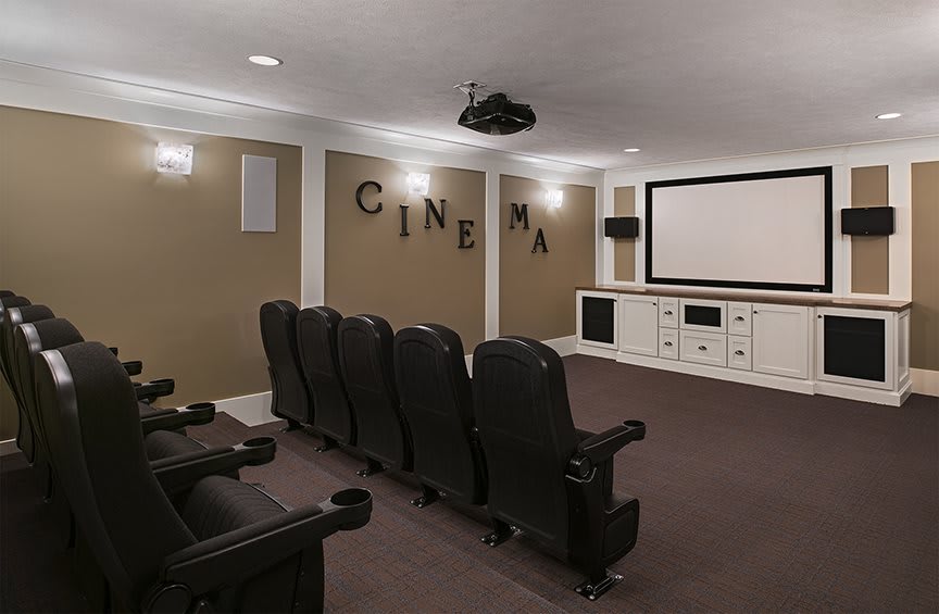 A modern home theater setup with comfortable seating and a large screen.
