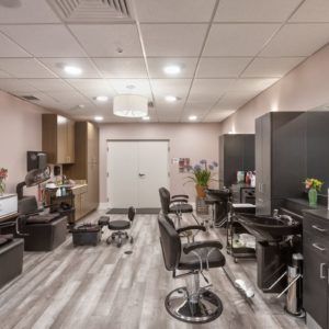 A modern salon interior with styling chairs and mirrors.