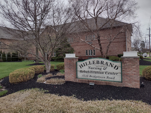 Entrance sign for Hillebrand Rehabilitation and Nursing Center, showcasing the landscaped area.