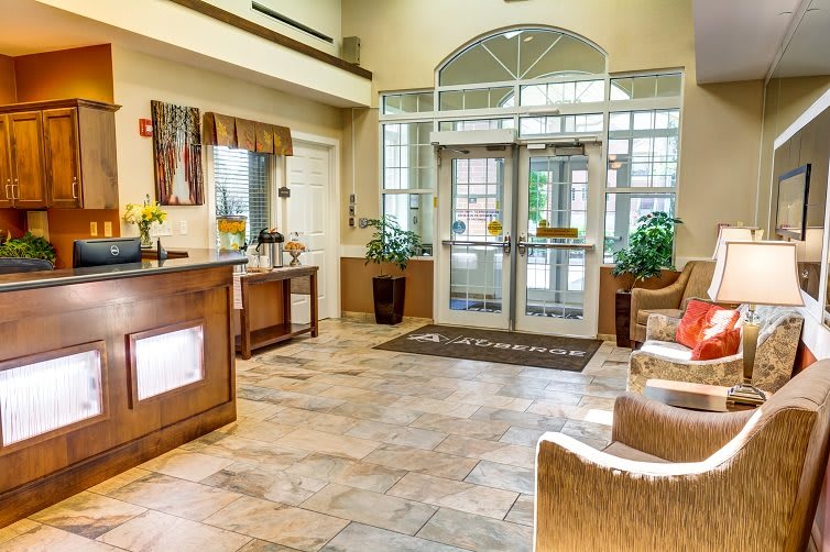 A welcoming hotel lobby with a reception desk and comfortable seating.
