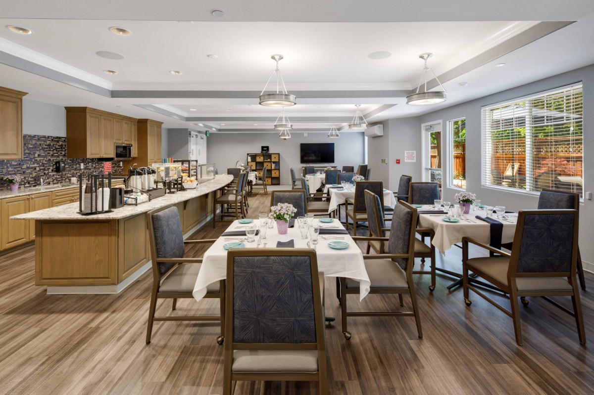 A modern dining room with neatly arranged tables and chairs, ready for guests.