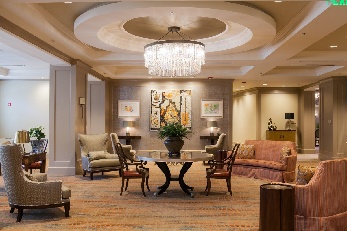 A luxurious hotel lobby with elegant furnishings and a grand chandelier.