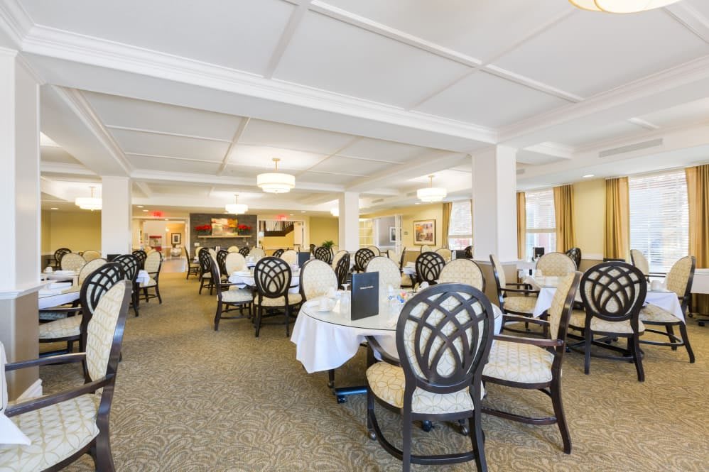 An elegant dining room with neatly arranged tables and chairs, ready for guests.