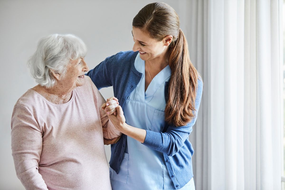 A nurse assists an elderly woman, showcasing compassion and care.