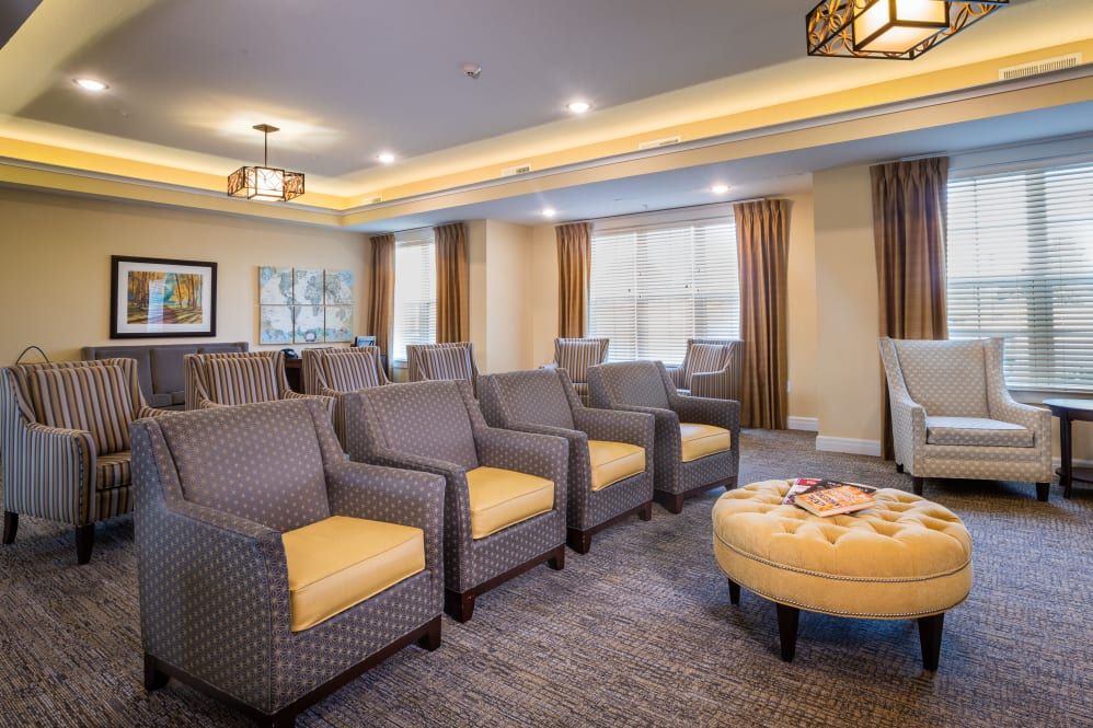 A cozy living room with arranged seating and warm lighting.