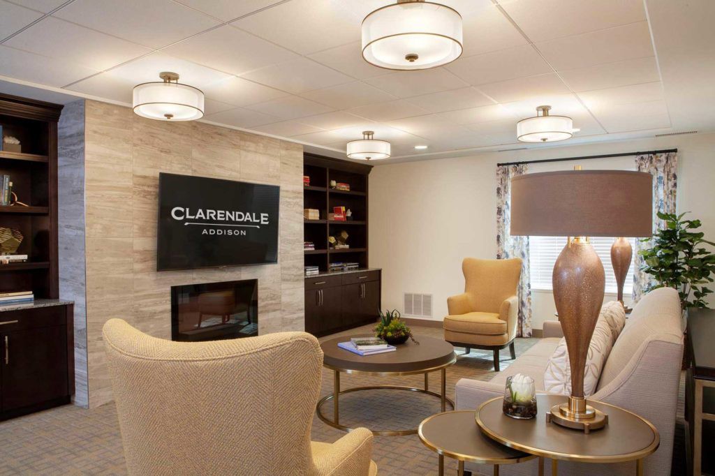 A modern and cozy living room featuring comfortable seating, a fireplace, and elegant decor.