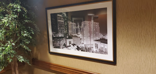 A striking black and white photograph showcasing a city skyline, elegantly framed and displayed on a wall.