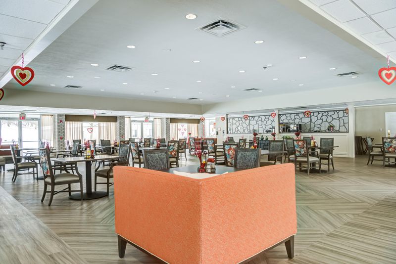 A modern restaurant interior with neatly arranged tables and chairs.