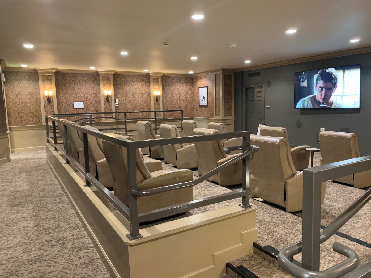 A luxurious home theater with comfortable seating and a large screen.