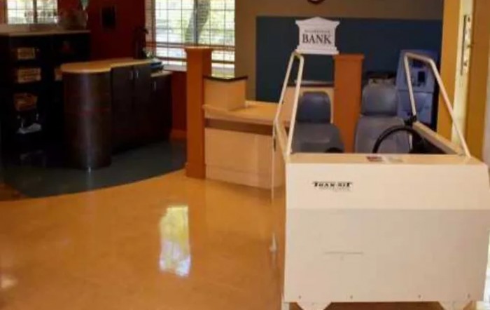 A waiting area in a clinic with chairs and a reception desk.