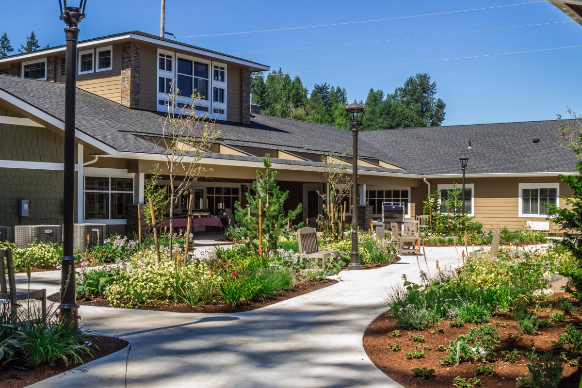 A landscaped garden pathway leading to a residential building.