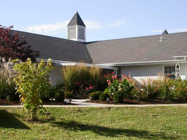 A church building surrounded by a landscaped garden.