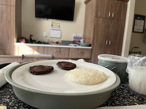A simple breakfast featuring rice and sausage.