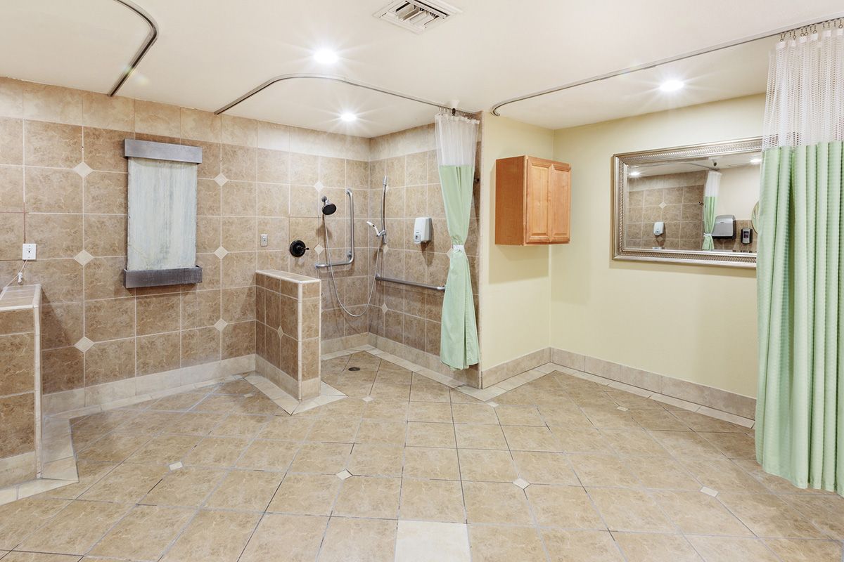 Spacious bathroom with a walk-in shower and accessibility features.